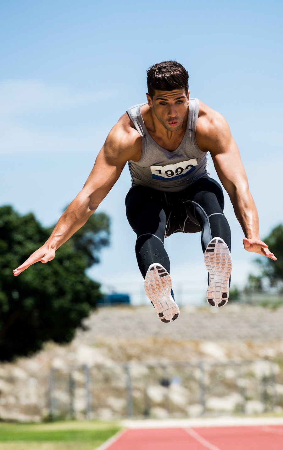 Athlete performing a long jump during a competition Extreme Sports Mountain Climbing